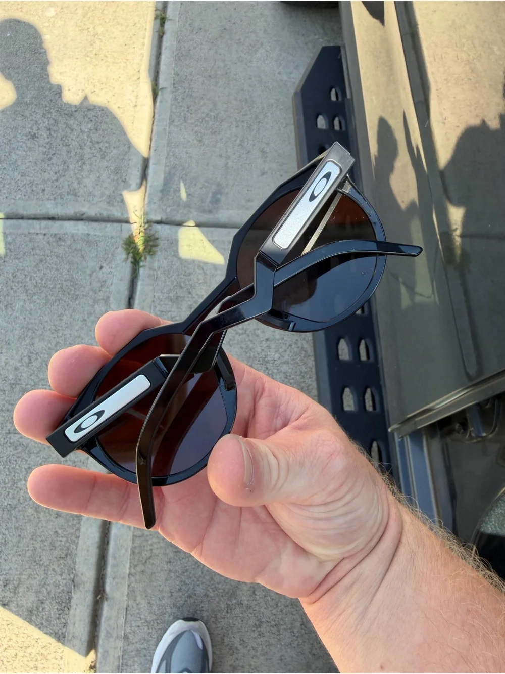 Oakley Men’s Black Round Frame Sunglasses with Silver Logo Accent